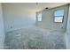 Clean bedroom with natural light and unfinished floors, ready for customization at 47333 W Coe St, Maricopa, AZ 85139