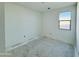 Bright bedroom featuring fresh paint and a large window overlooking outdoors at 47333 W Coe St, Maricopa, AZ 85139
