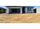Exterior shot of home with an open garage, showing unfinished landscaping at 47333 W Coe St, Maricopa, AZ 85139