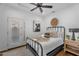 Cozy bedroom features a ceiling fan, wooden floors, and access to an exterior patio area at 4809 E Red Range Way, Cave Creek, AZ 85331