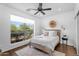 Inviting bedroom with neutral tones, natural light, wood flooring, and ceiling fan at 4809 E Red Range Way, Cave Creek, AZ 85331