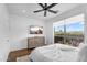 Bright bedroom featuring wood floors, a large window, and a modern dresser with a wall-mounted television at 4809 E Red Range Way, Cave Creek, AZ 85331