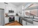 Beautifully updated kitchen featuring stainless steel appliances, a modern sink, and ample cabinet space at 4809 E Red Range Way, Cave Creek, AZ 85331