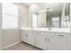 Bathroom with a double sink vanity, large mirror, and tiled floors with natural light at 4833 S Ferric --, Mesa, AZ 85212