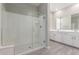 Bright bathroom featuring a glass-enclosed shower and a dual sink vanity with white cabinetry at 4833 S Ferric --, Mesa, AZ 85212