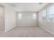 Light-filled bedroom with neutral walls, plush carpeting, and ample natural light from large windows at 4833 S Ferric --, Mesa, AZ 85212