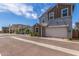 View of a two-story home featuring gray and brown siding, with an attached garage at 4833 S Ferric --, Mesa, AZ 85212