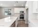 Modern kitchen featuring a large island with sink, stainless steel appliances, and white cabinetry at 4833 S Ferric --, Mesa, AZ 85212