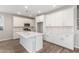 Bright kitchen with white cabinets, island, stainless steel appliances, and quartz countertops at 4833 S Ferric --, Mesa, AZ 85212