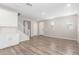 Open-concept living room showcasing wood-look floors, white walls, and seamless transition to the kitchen at 4833 S Ferric --, Mesa, AZ 85212