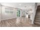 Bright, open-concept living room with wood floors flowing into a kitchen with an island and modern appliances at 4833 S Ferric --, Mesa, AZ 85212