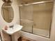 Clean bathroom featuring a pedestal sink and a bathtub with sliding glass doors at 520 S Evergreen Rd, Tempe, AZ 85288