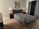 Comfortable bedroom with a queen-sized bed, neutral walls, and bedside tables with lamps at 520 S Evergreen Rd, Tempe, AZ 85288