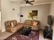 Cozy living room with plush seating, ceiling fan, and a neutral color palette at 520 S Evergreen Rd, Tempe, AZ 85288