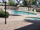 Community pool area with lounge chairs, umbrellas, and jacuzzi for relaxing outdoor enjoyment at 520 S Evergreen Rd, Tempe, AZ 85288