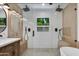 Beautiful dual shower with glass door and bench and dual shower heads, adjacent to vanity with double sink and mirror at 5425 E Avalon Dr, Phoenix, AZ 85018