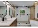 Stunning bathroom featuring a double sink vanity, and a glass enclosed shower with dual shower heads and built-in bench at 5425 E Avalon Dr, Phoenix, AZ 85018