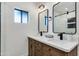 Elegant bathroom with double sinks, quartz countertop, wood cabinets, and walk-in shower at 5425 E Avalon Dr, Phoenix, AZ 85018