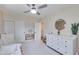 Well-lit bedroom with soft decor, ceiling fan, minimalist furniture, and ample closet space at 5425 E Avalon Dr, Phoenix, AZ 85018