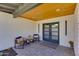 Stylish entryway featuring wood ceilings, double doors, and a comfortable seating arrangement at 5425 E Avalon Dr, Phoenix, AZ 85018