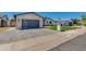 Charming exterior features brick accents, gray garage door, and well-manicured lawn at 5425 E Avalon Dr, Phoenix, AZ 85018