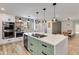 Bright kitchen with white cabinets, stainless appliances, and an island with cooktop at 5425 E Avalon Dr, Phoenix, AZ 85018