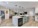 Spacious kitchen island with seating, a wine fridge, and open layout to the living area at 5425 E Avalon Dr, Phoenix, AZ 85018