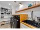Well-organized laundry room with modern appliances, sink, butcher block countertop, and ample storage at 5425 E Avalon Dr, Phoenix, AZ 85018