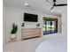 Bright main bedroom featuring a ceiling fan, dresser, and sliding glass doors to patio at 5425 E Avalon Dr, Phoenix, AZ 85018