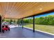 Spacious covered patio includes wood ceiling, access to play area and expansive backyard views at 5425 E Avalon Dr, Phoenix, AZ 85018