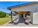 Covered patio features hanging chairs, television and access to backyard and play area at 5425 E Avalon Dr, Phoenix, AZ 85018