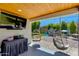 Relaxing covered patio includes television, hanging chairs and access to outdoor play area at 5425 E Avalon Dr, Phoenix, AZ 85018