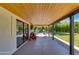 Covered patio features wood ceiling, concrete floors, backyard views and access to play area at 5425 E Avalon Dr, Phoenix, AZ 85018