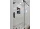 Stylish walk-in shower with vertical tiling, pebble floor, and glass door for a luxurious feel at 5425 E Avalon Dr, Phoenix, AZ 85018