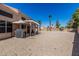 View of the backyard with desert landscaping, covered patio, and shade trees is perfect for entertaining and relaxing at 610 S St Paul --, Mesa, AZ 85206