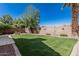 Large backyard with a lush lawn, a patio, and desert landscaping create a relaxing outdoor retreat at 610 S St Paul --, Mesa, AZ 85206