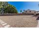 Spacious backyard with desert landscaping, stepping stones, and mature trees offers ample room for outdoor activities at 610 S St Paul --, Mesa, AZ 85206