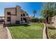 View of expansive backyard featuring manicured lawn, desert landscaping, patio, and home's exterior at 610 S St Paul --, Mesa, AZ 85206