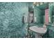 Stylish half-bathroom with unique wall texture, pedestal sink, and decorative lighting at 610 S St Paul --, Mesa, AZ 85206