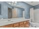 Bathroom with blue walls, white countertops, and a shower/tub combo at 610 S St Paul --, Mesa, AZ 85206