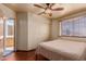 Bedroom with neutral walls, wood-look floors and a queen-size bed with neutral bedding at 610 S St Paul --, Mesa, AZ 85206
