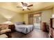 Cozy bedroom with wood floors, a ceiling fan, and a sliding glass door to the backyard at 610 S St Paul --, Mesa, AZ 85206