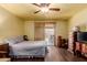 Bedroom with wood floors, ceiling fan, and a sliding glass door to the backyard at 610 S St Paul --, Mesa, AZ 85206