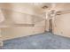 Loft area with blue carpet, ceiling fan, and view into the downstairs area at 610 S St Paul --, Mesa, AZ 85206