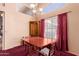 Traditional dining room with large windows, chandelier, wood table, cabinet, and red carpeting at 610 S St Paul --, Mesa, AZ 85206