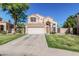 Charming two-story home with a well-maintained lawn, desert landscaping, and an attached two-car garage at 610 S St Paul --, Mesa, AZ 85206