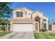 Attractive two-story home featuring desert landscaping, neutral stucco, a tile roof, and an attached two-car garage at 610 S St Paul --, Mesa, AZ 85206
