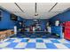 Garage with blue walls and blue-and-white checkerboard flooring with a variety of storage options at 610 S St Paul --, Mesa, AZ 85206