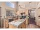 Well-lit kitchen with granite countertops, an island, and stainless steel appliances at 610 S St Paul --, Mesa, AZ 85206