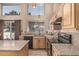 Sunlit kitchen featuring granite countertops and ample natural light from large windows at 610 S St Paul --, Mesa, AZ 85206